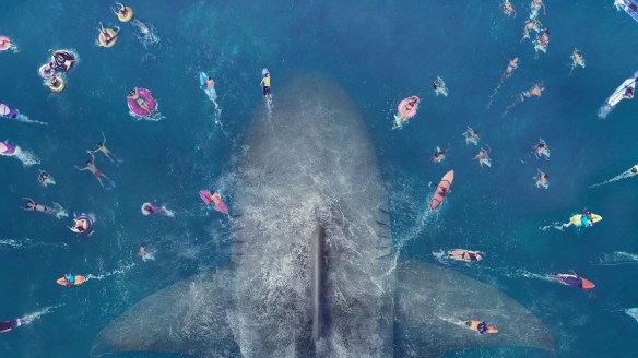 A giant shark underneath a crowd of swimmers.