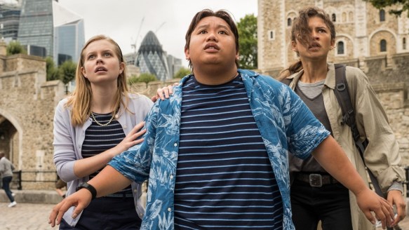 Betty (Angourie Rice), Ned (Jacob Batalon) and MJ (Zendaya) looking at something high up with scared expressions.