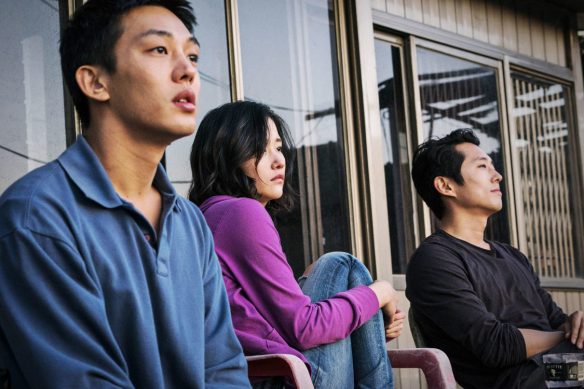 Three young people (Ah-in Yoo, Steven Yeun, Jong-seo Jun) sitting on a porch.