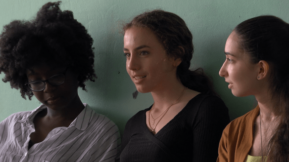 Three teenage girls talking.