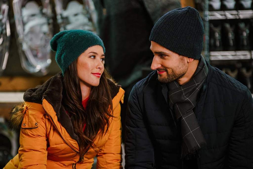 A woman (Kaitlyn Leeb) and a man (Scott Cavelheiro) sitting next to each other. 