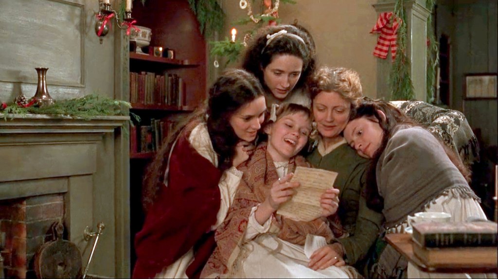The four March girls (Winona Ryder, Trini Alvarado, Kirsten Dunst, Claire Danes) huddled around their mother (Susan Sarandon) to read a letter from their father.