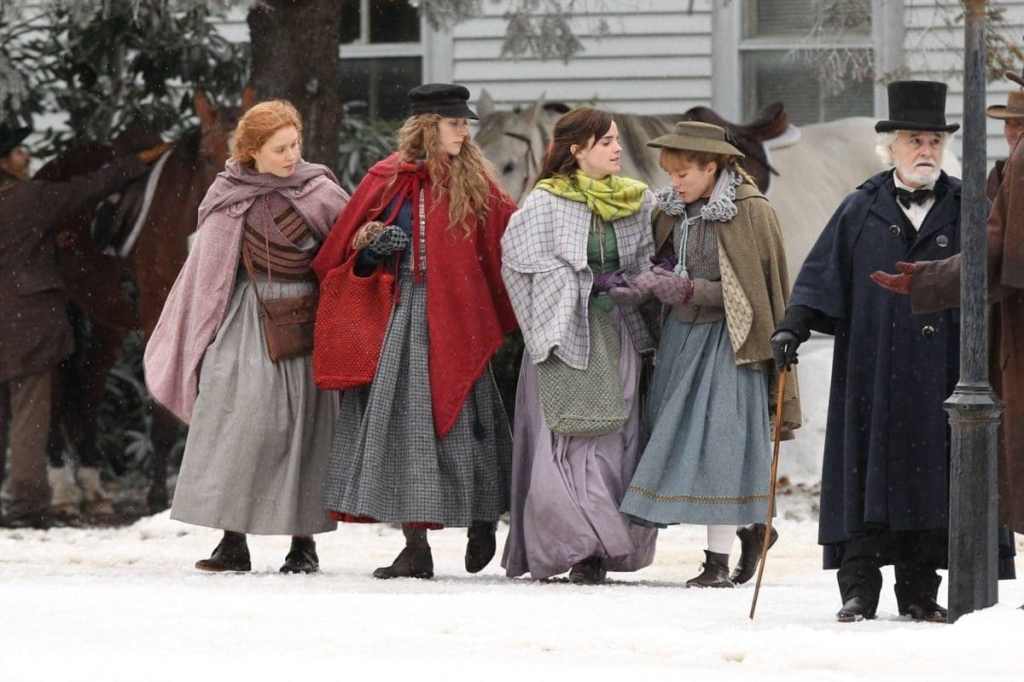 The four Marsh girls (Saoirse Ronan, Emma Watson, Florence Pugh, Eliza Scanlen) walking through town.