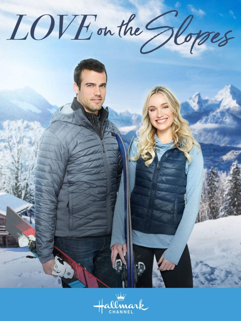 The film poster showing a man (Thomas Beaudoin) and a woman (Katrina Bowden) standing on a snowy mountain with skis in their hands.