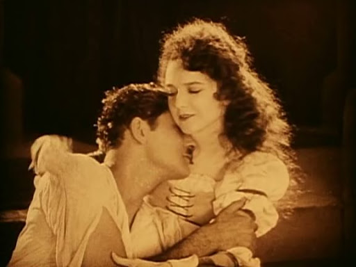 Christine (Mary Philbin) hugs Raoul (Norman Kerry).