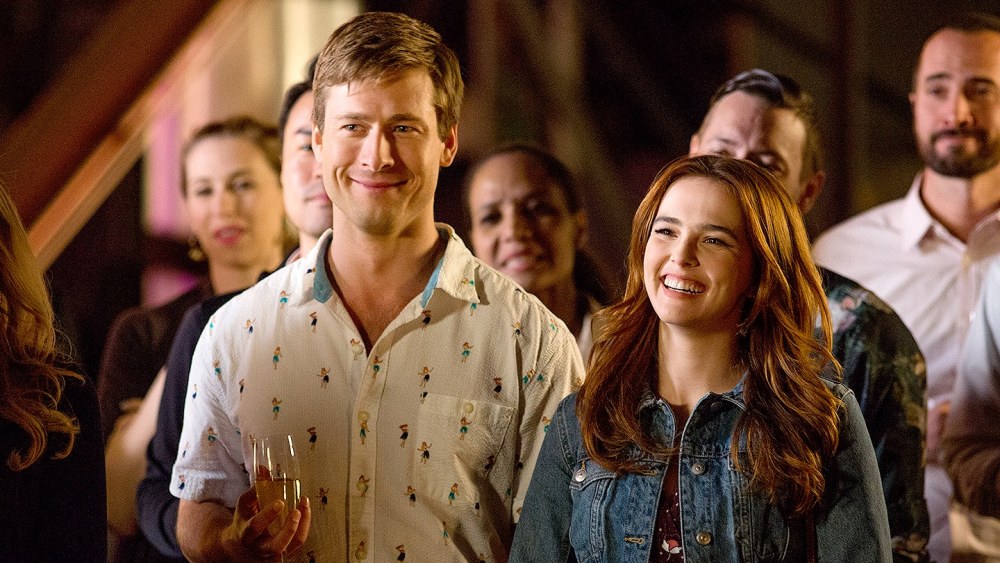 Charlie (Glen Powell) and Harper (Zoey Deutch) standing next to each other, smiling. 