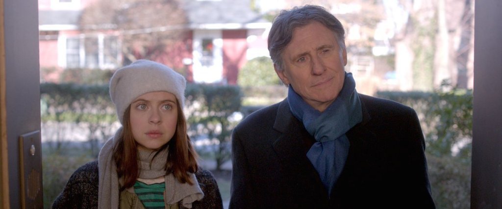 Carrie (Bel Powley) and her father (Gabriel Byrne) standing in front of a door. 