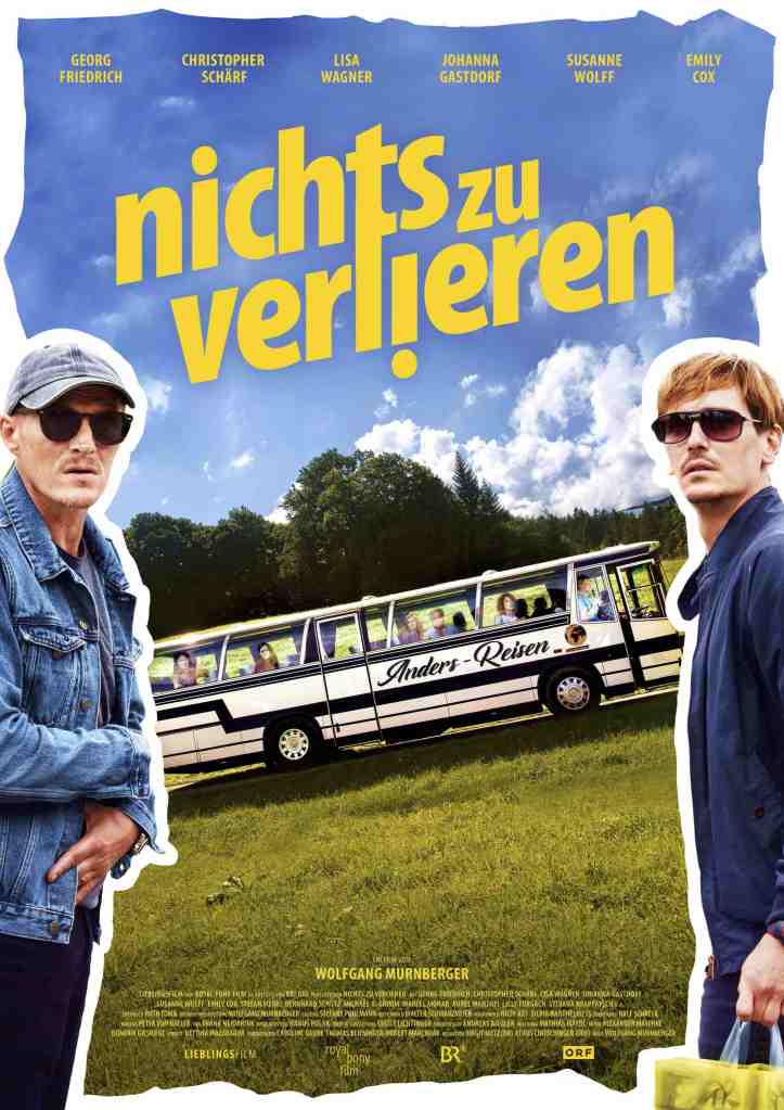 The film poster showing a bus on a meadow and Richy (Georg Friedrich) and Tom (Christopher Schärf) standing in front of it with nonplussed expressions.
