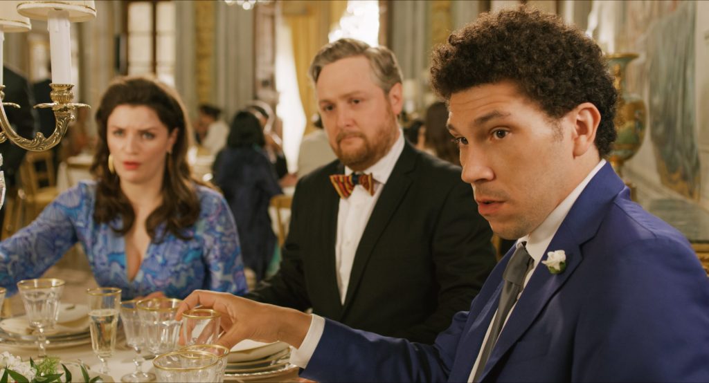Bryan (Joel Fry), Sidney (Tim Key) and Rebecca (Aisling Bea) at the dinner table. 