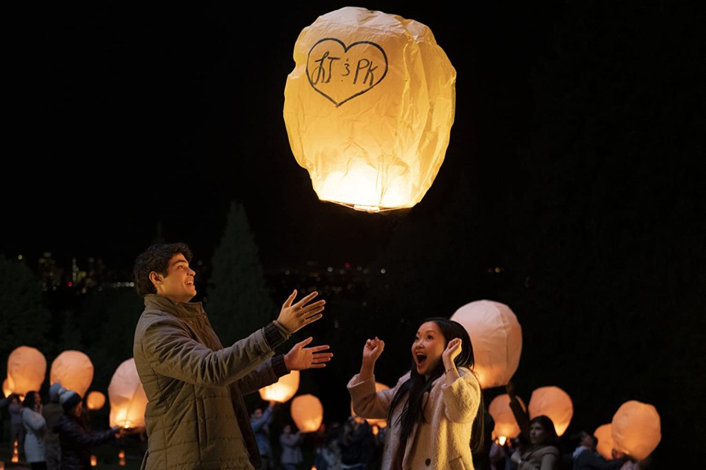 Peter (Noah Centineo) and Lara Jean (Lana Condor) make a lantern with a wish fly. 