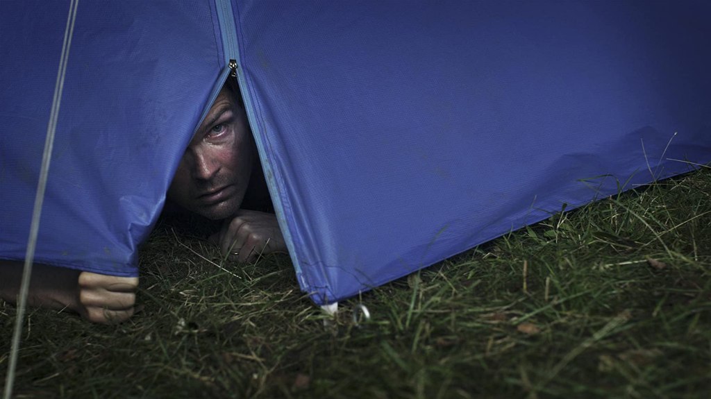 Tobias (Leif Edlund) peeking out of his tent.