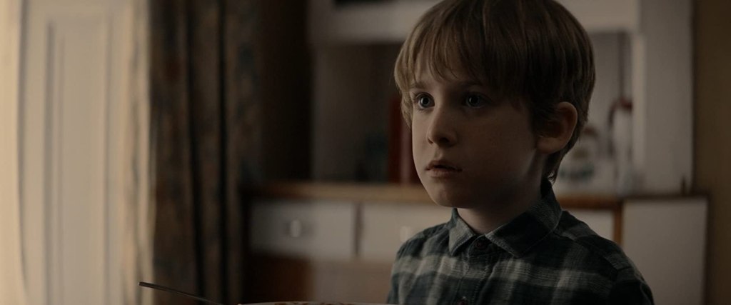 Chris (James Quinn Markey) with an anxious facial expression.