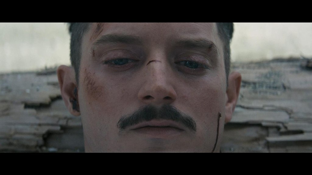 Norval (Elijah Wood) looking beat up.