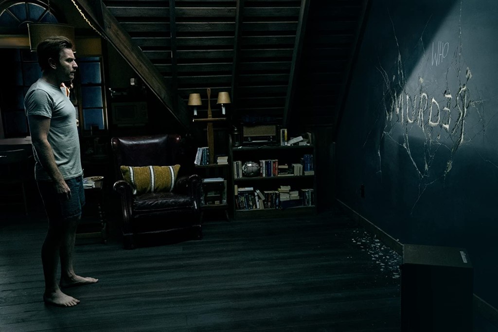 Dan (Ewan McGregor) staring at the wall where the word "Murder" is wirtten in cracks. 