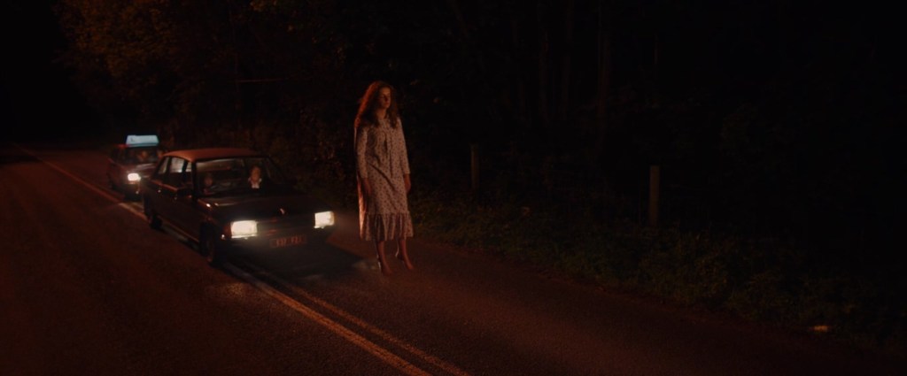 Two cars following a levitating teenage girl.