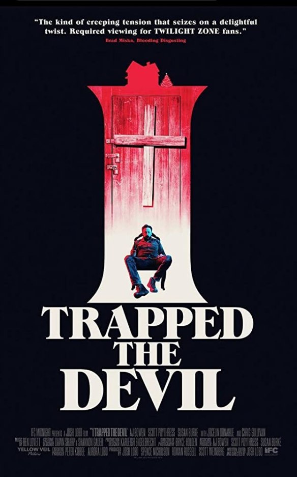 The film poster showing a red door in front of black background with a man tied to a chair sitting in front of it.