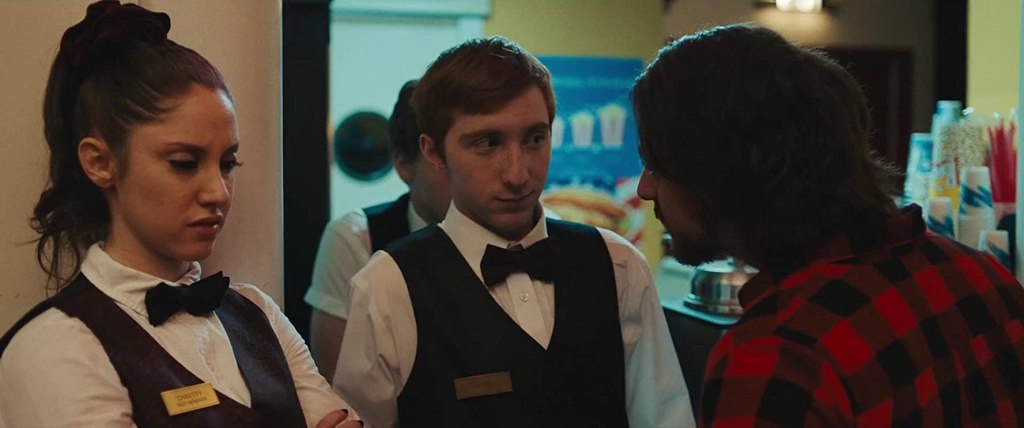 Chaz (Jiliian Mueller) and Todd (Larry Saperstein) talking to Heavy Metal Jeff (Robbie Tann). 