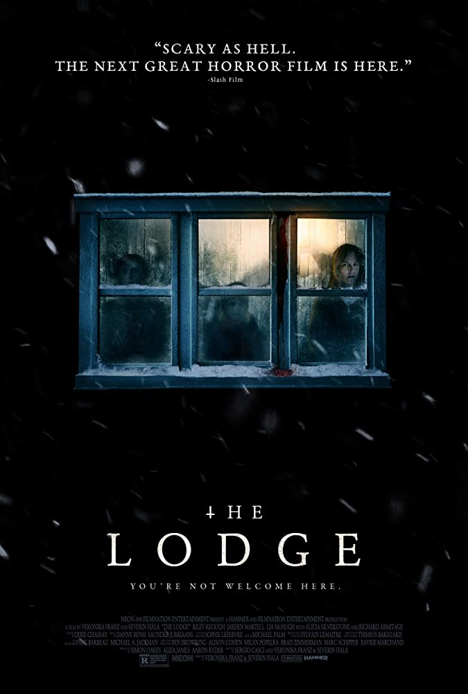 The film poster showing a window from a cabin in the snow, three blurry humans can be seen inside.