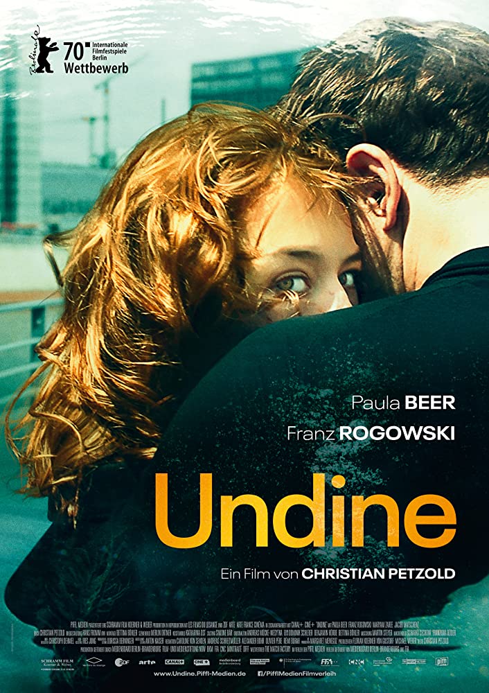 The film poster showing Undine (Paula Beer) in Christoph's (Franz Rogowski) arms, looking back over his shoulder.