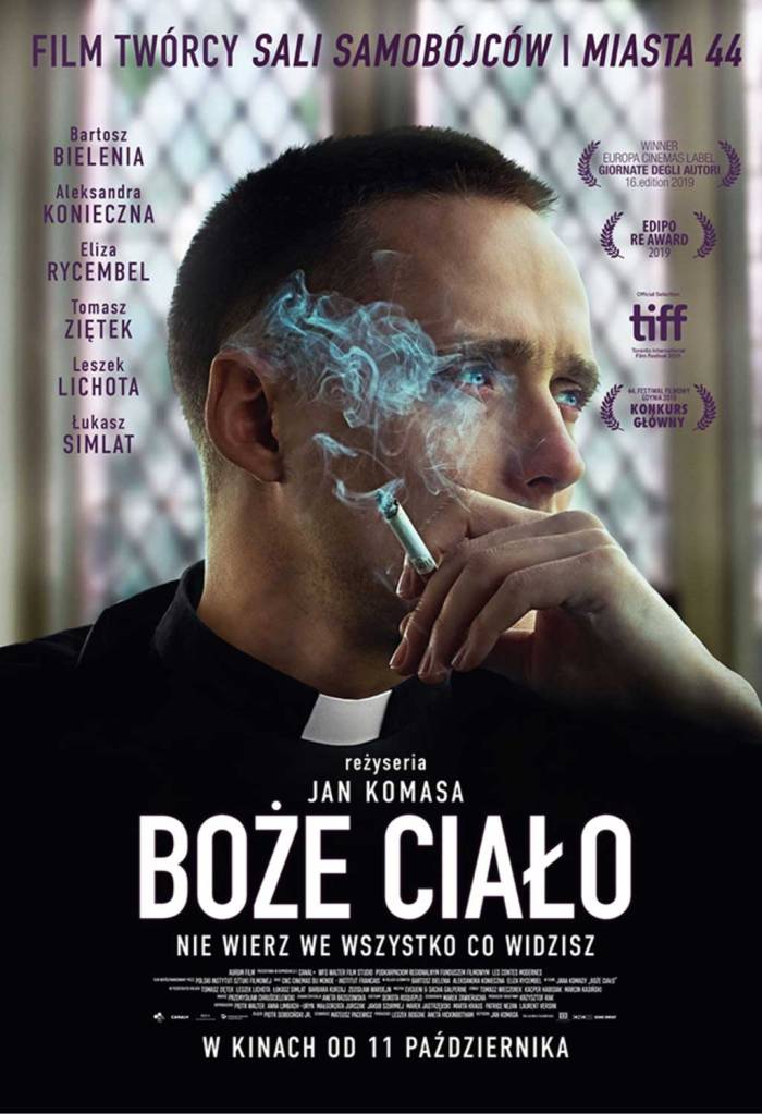 The film poster showing Daniel (Bartosz Bielenia) in a priest's robe, cigarette in hand.