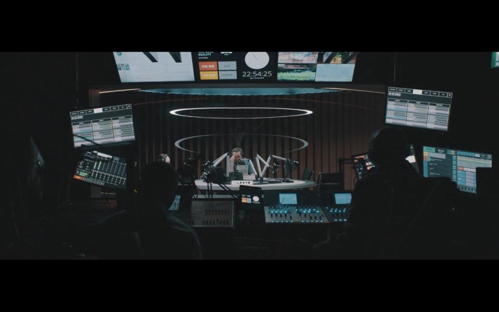 Jarvis (Eddie Marsan) sitting in the radio studio. 