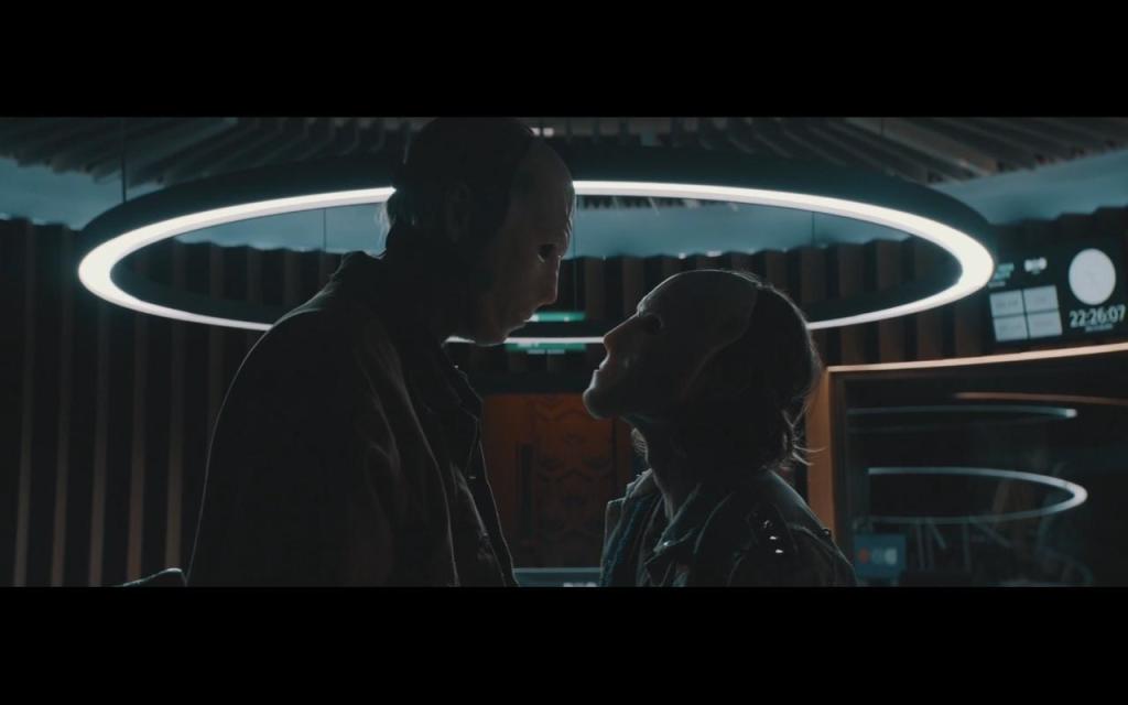 Two masked men looking at each other inside the radio studio. 