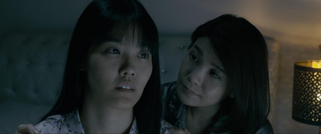 Mei Xi (Emily Lim) comforting Mei Yue (Lim Mei Fen) who looks dazed. 