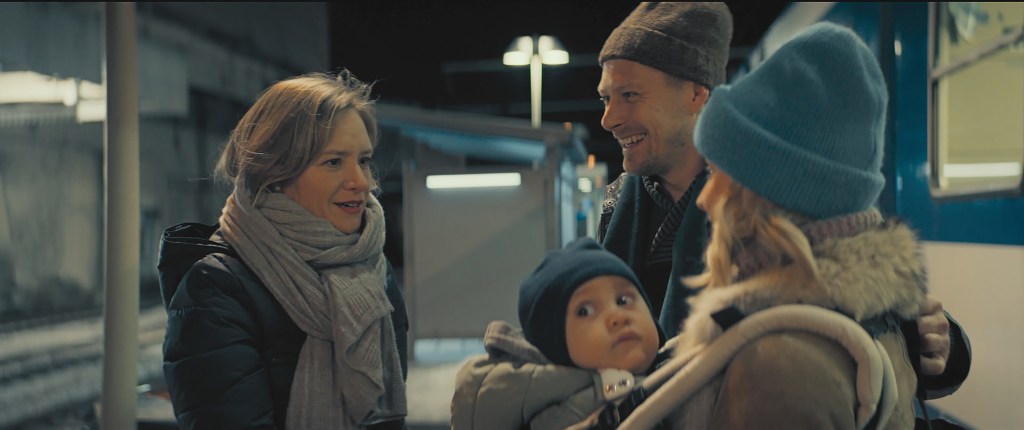 Helene (Julia Jentsch) greeting Pavel (Tambet Tuisk), his wife Eugenia (Lena Tronina) and their baby at the train station. 