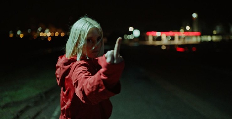 Eve (Lucie Debay) giving the finger.