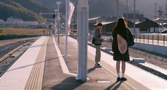 Haru (Serena Motola) at the train station.