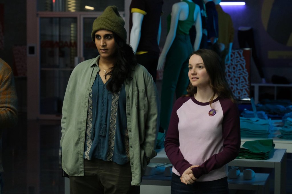 Shruit (Sehar Bhojani) and Libby (Romane Denis) at a staff meeting.