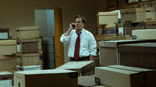 Rob Bilott (Mark Ruffalo) standing in a room full of document boxes.