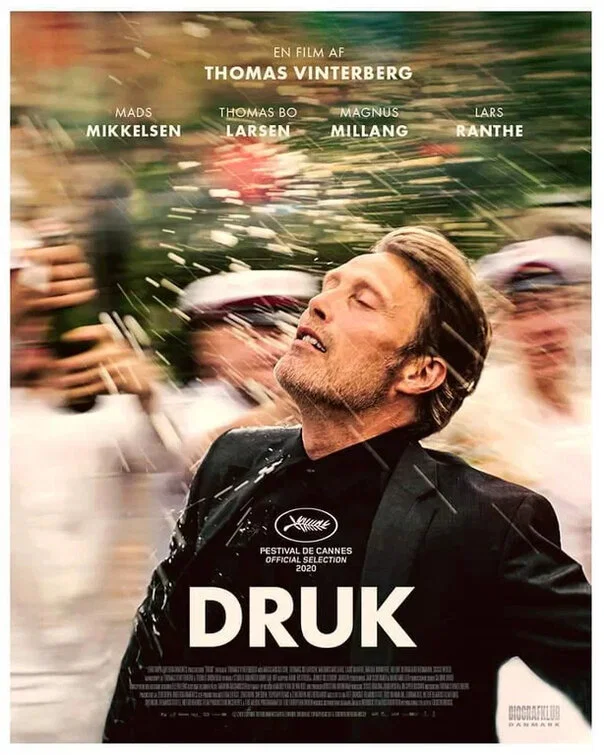 The film poster showing Martin (Mads Mikkelsen) running through a champagne shower, the background completely blurry.