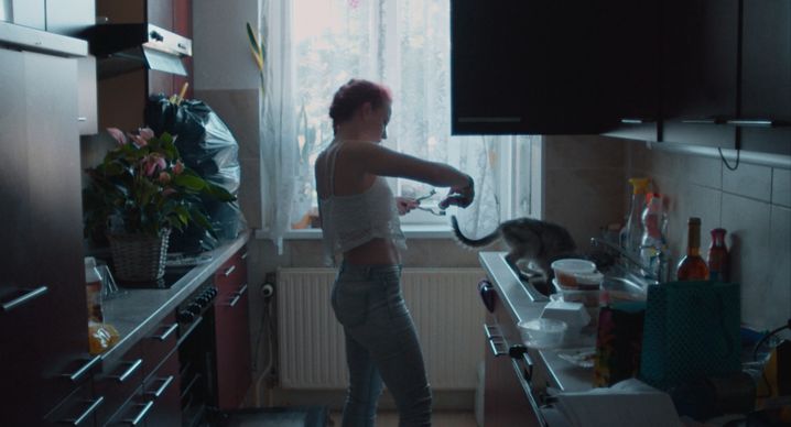 Claudia feeding her cat.