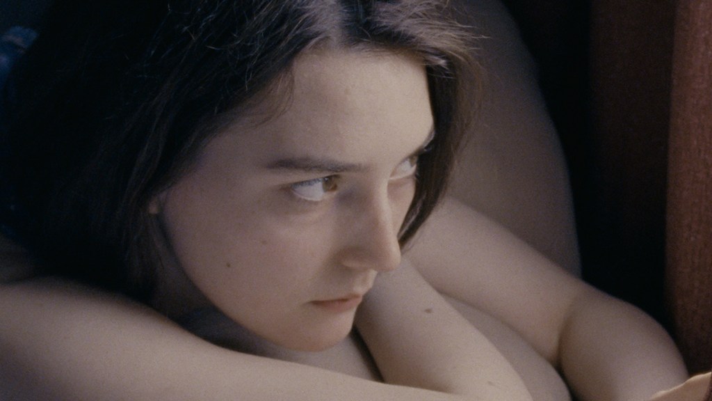 Autumn (Sidney Flanigan) looking out the window.