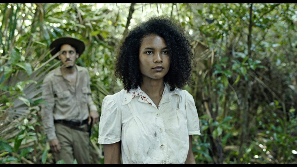 Agnes (Indira Rubie Andrewin) walking through the jungle. 