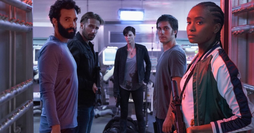 Joe (Marwan Kenzari), Booker (Matthias Schoenaerts), Andy (Charlize Theron), Nicky (Luca Marinelli) and Nile (KiKi Layne), all looking towards the camera.