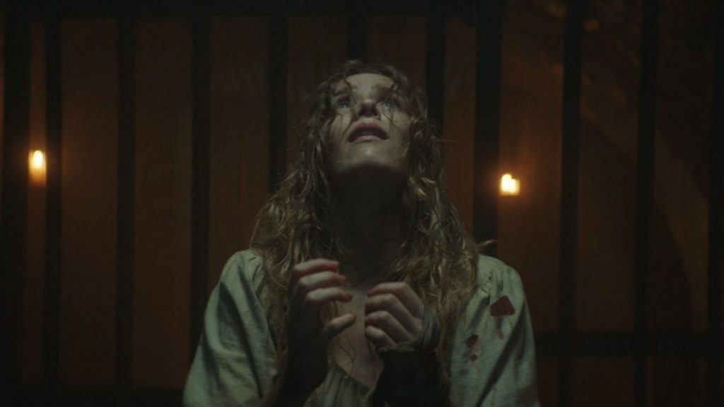 A dishevelled Grace (Charlotte Kirk) looking towards heaven.