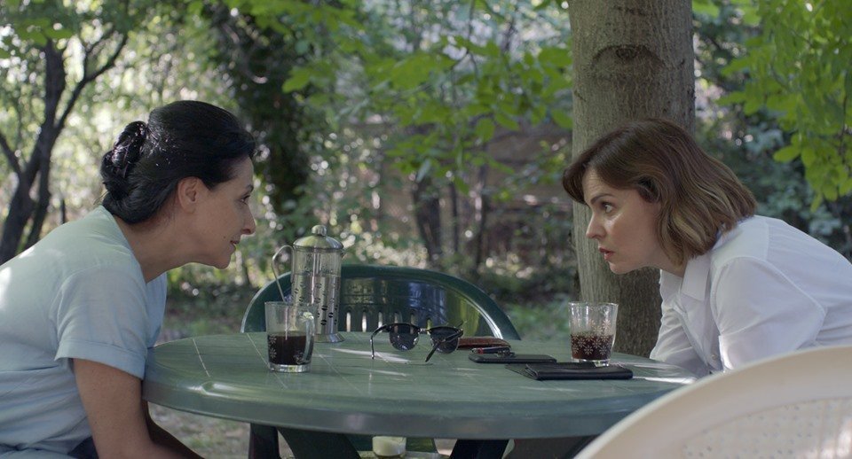 Adult Nana (Ketevan Gegeshidze) and Irina (Nino Kasradze) looking at each other.