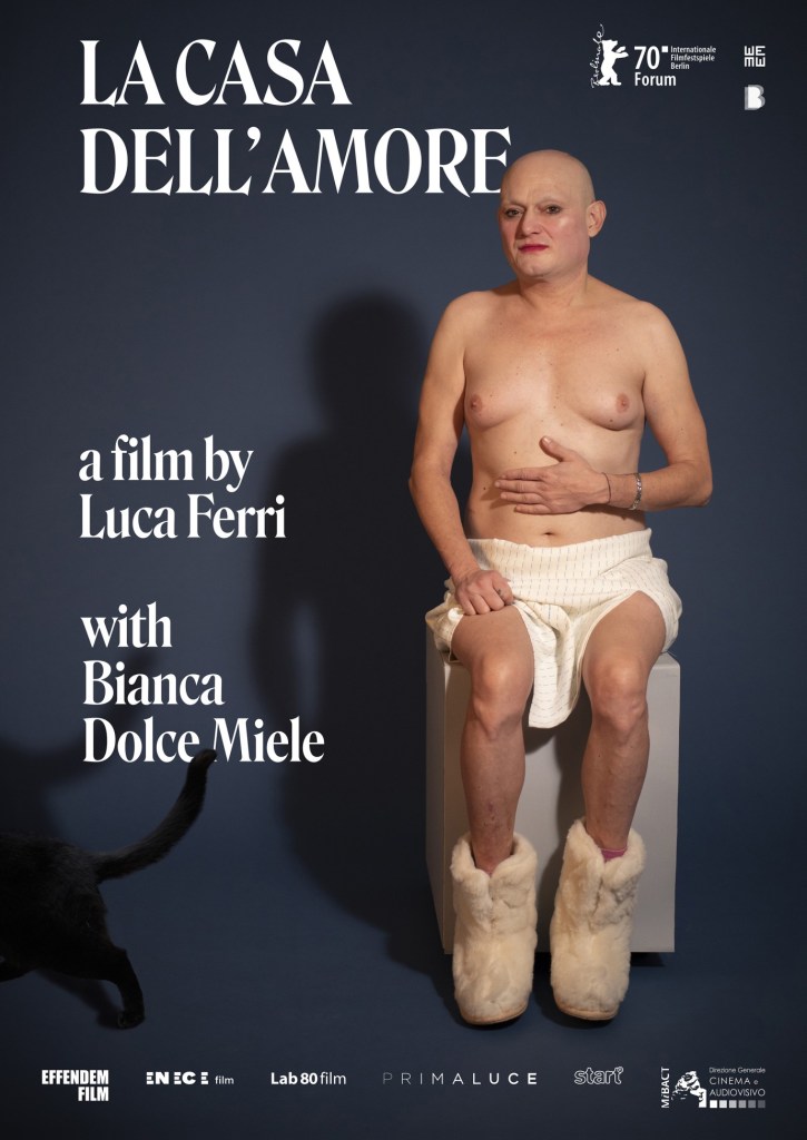 The film poster showing Bianca half-naked, sitting on a whie cube, wearing nothing but a white skirt and white furry boots. A black cat's but is also in the picture in the corner.