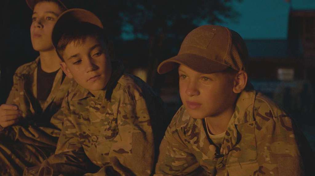 Jastrip with a couple of boys next to a fire at night.