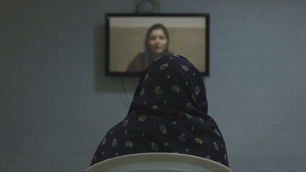 One of the mothers watches her daughter's video message.