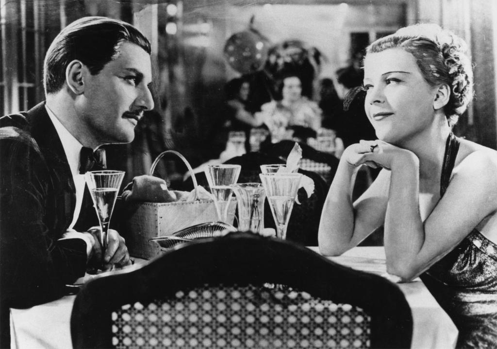 Philip (Anton Walbrook) and Viola (Renate Müller) at dinner on the cruise ship. 