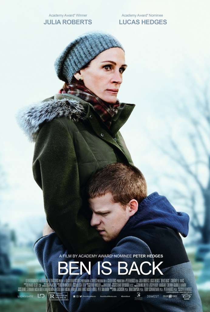 Ben (Lucas Hedges) kneeling in front of his mother Holly (Julia Roberts), hugging her tightly.