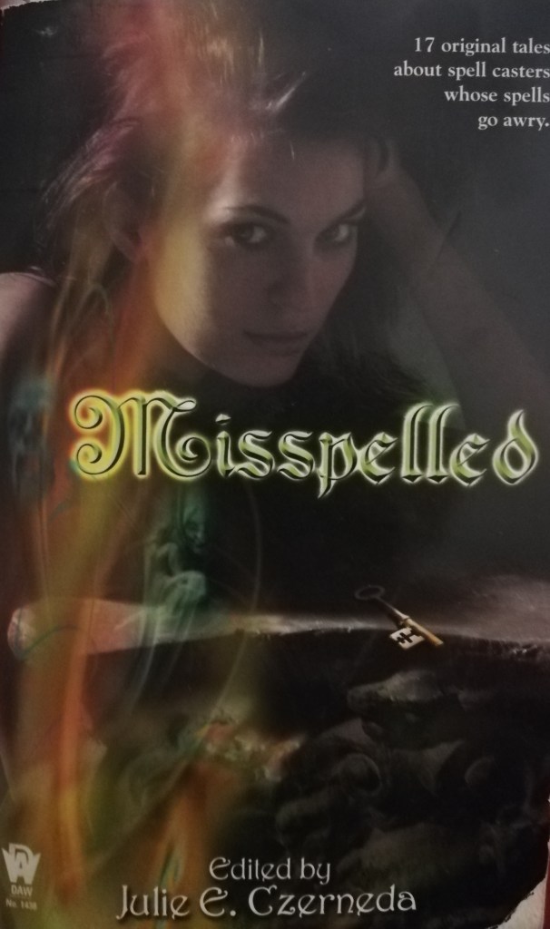The books cover showing a young woman leaning on a stone table with a key on it, with a kind of lens-flare effect over the image that includes a couple of ghostly figures.