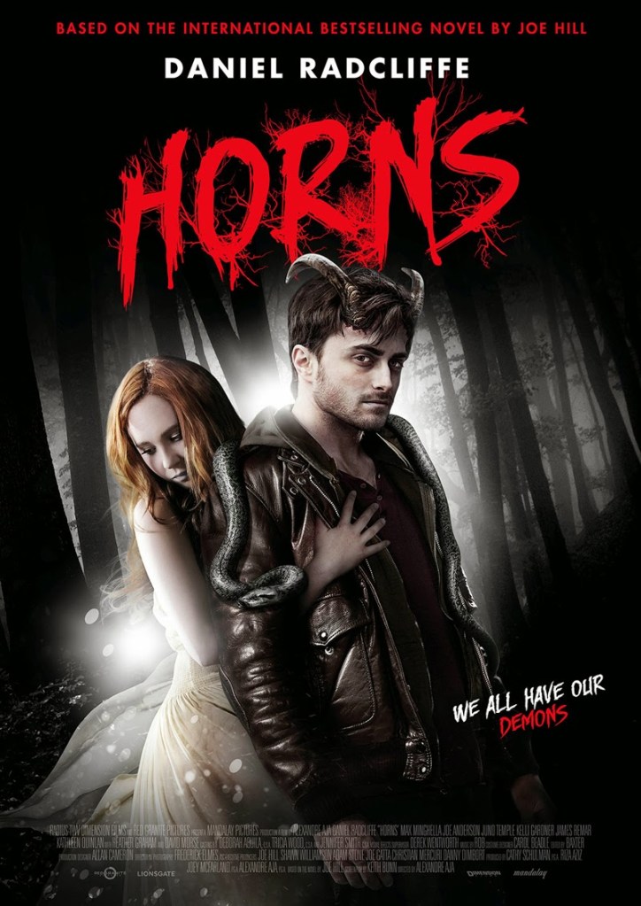 The film poster showing Ig (Daniel Radcliffe) with his horns and a snake over his shoulders. Merrin (Juno Temple is holding on to him from behind. 