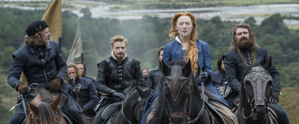 Mary Stuart (Saoirse Ronan) riding with a small group of men. 