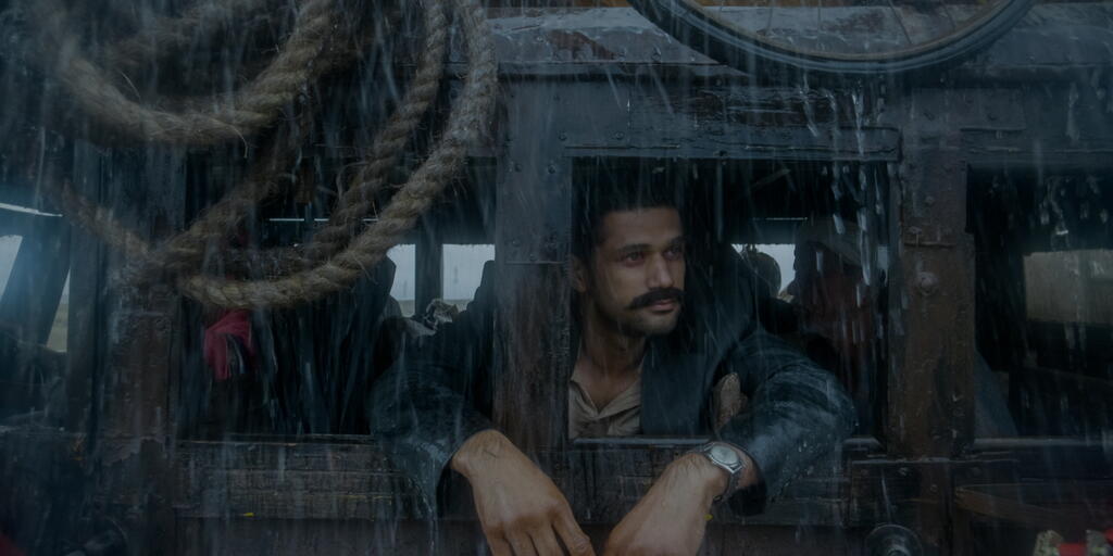 Vinayak (Sohum Shah) on a bus, looking out the window.