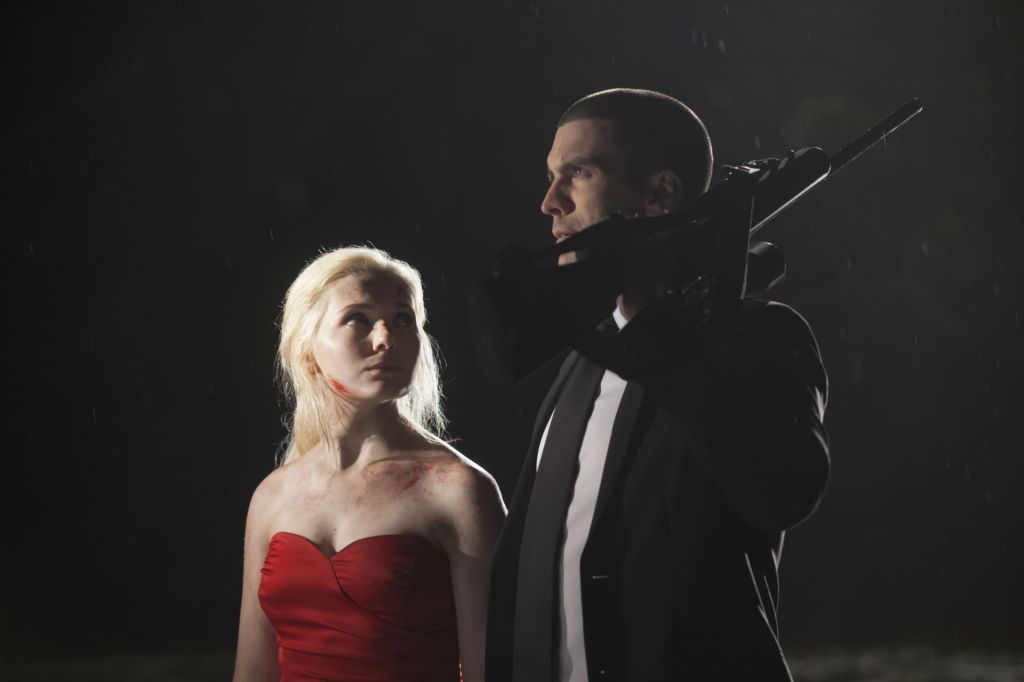 Veronica (Abigail Breslin) looking up at William (Wes Bentley) who has a gun over his shoulder.
