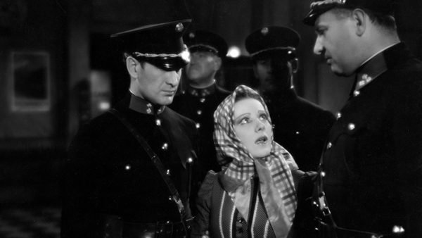 Katharina (Franciska Gaal) surrounded by police men.